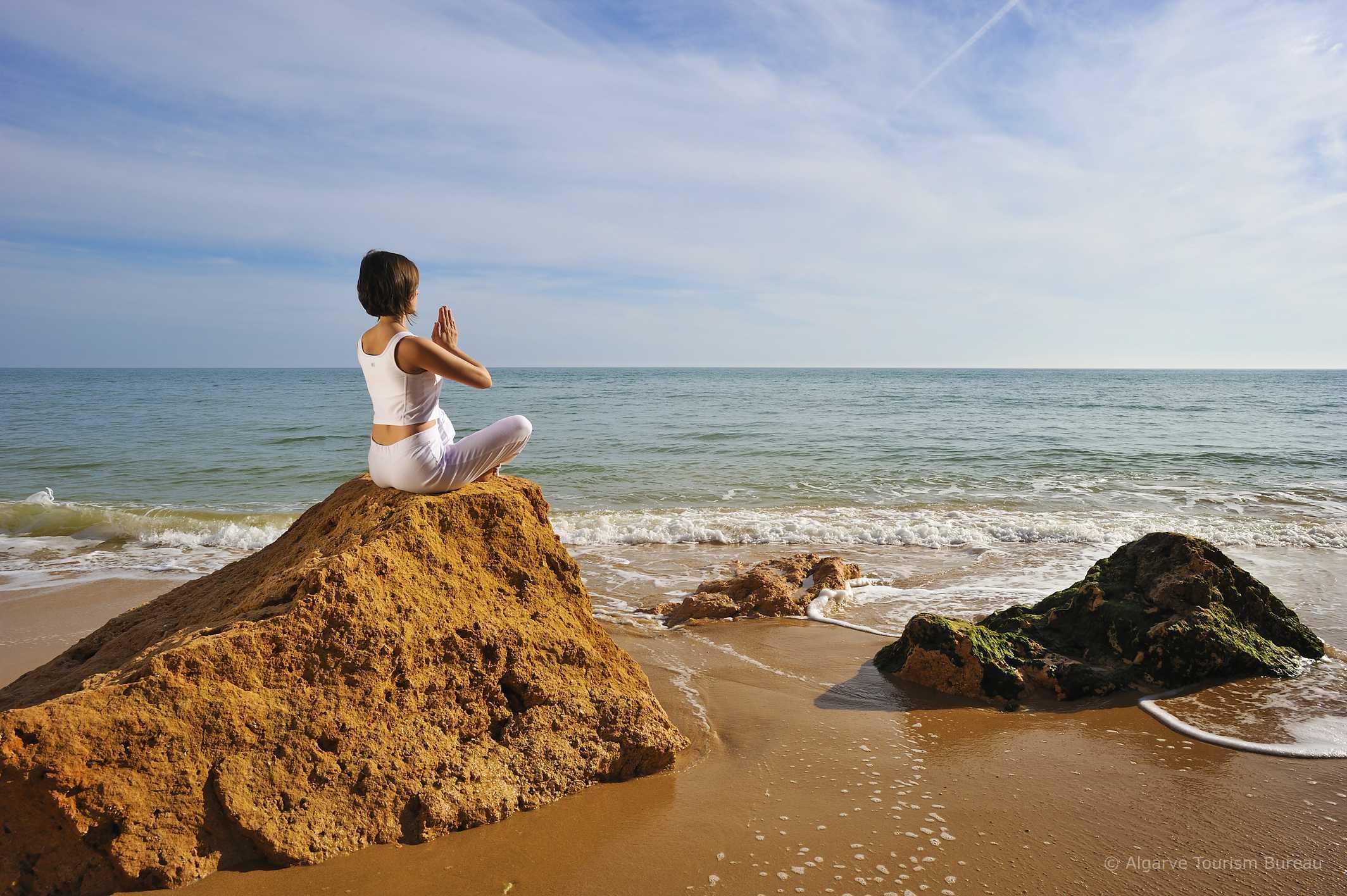 Meditating on beach in the Algarve